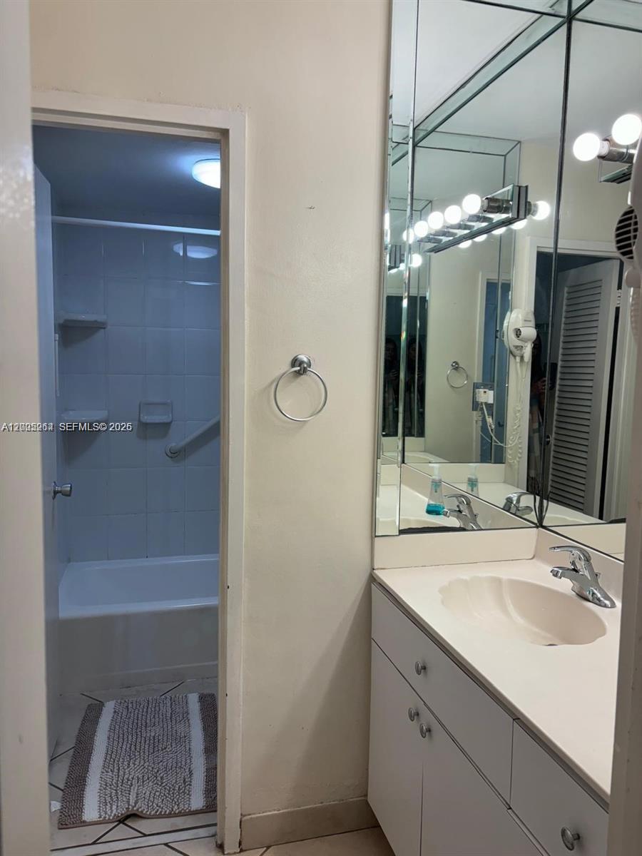 100 Lincoln Road, Unit 731 Miami Beach, FL 33139 - Photo 10 of 14 a bathroom with a sink vanity and shower