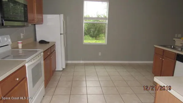 a kitchen with a sink a stove and a refrigerator