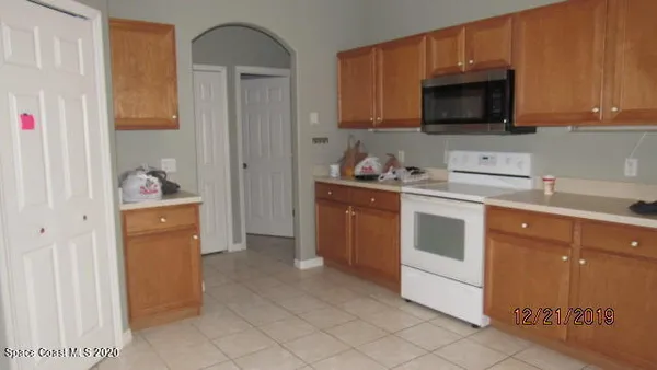 a kitchen with stainless steel appliances a stove microwave and sink