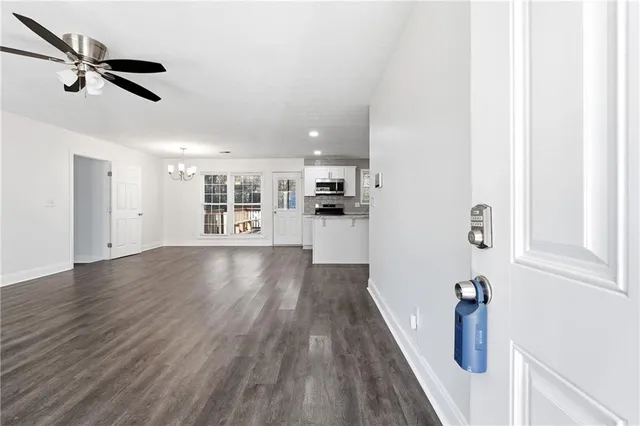 a view of empty room with wooden floor