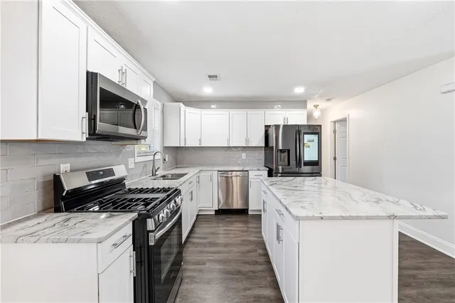 a kitchen with a sink stove and refrigerator