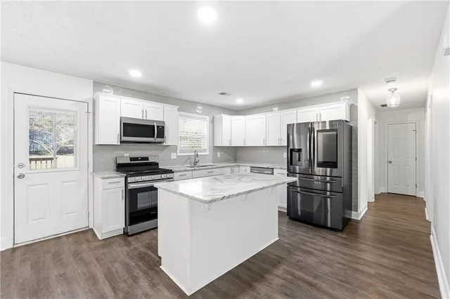 a kitchen with stainless steel appliances a stove sink and refrigerator