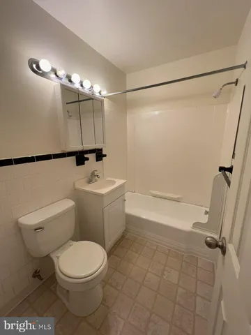a white toilet sitting next to a bathroom sink
