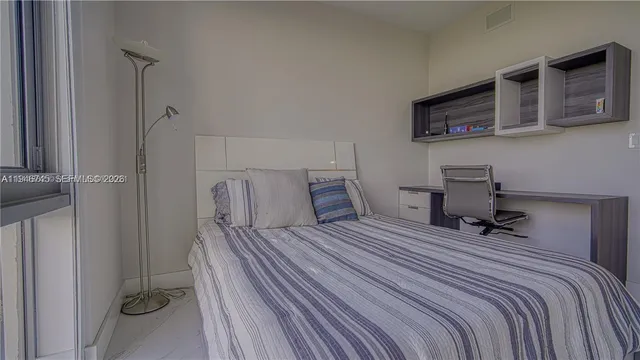 a bedroom with a bed and a table in it