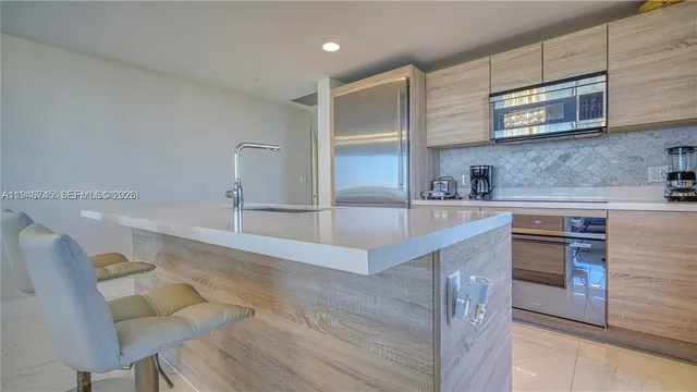 a kitchen with stainless steel appliances granite countertop a sink and a microwave