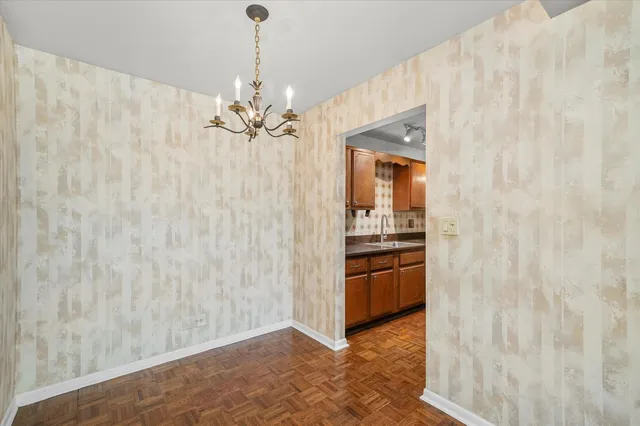 a view of a kitchen with a sink and dishwasher a refrigerator with wooden floor