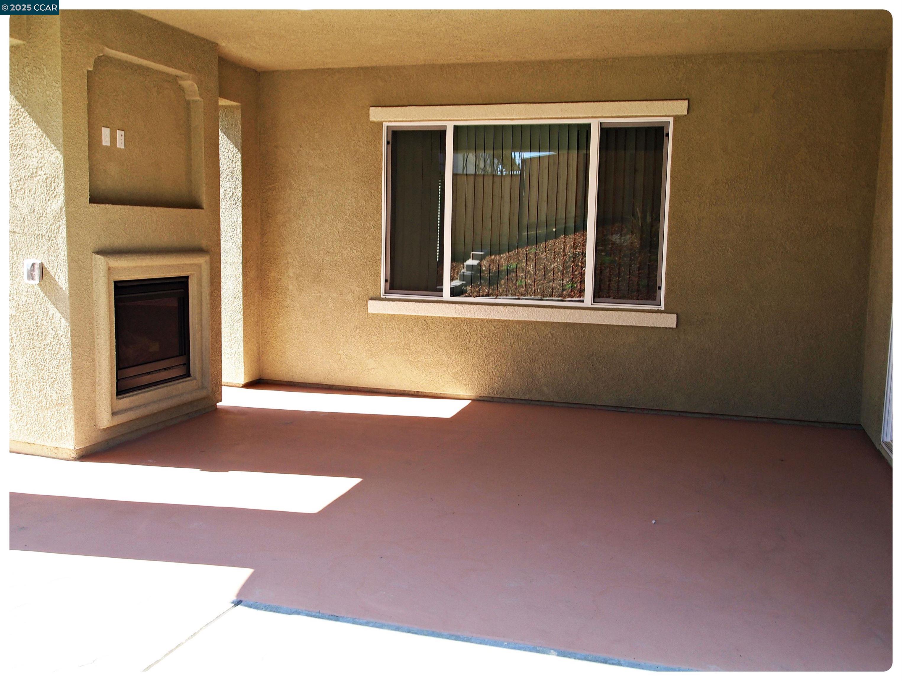 5603 Ventry Way Antioch, CA 94531 - Photo 13 of 19 a view of an empty room with a fireplace and a window