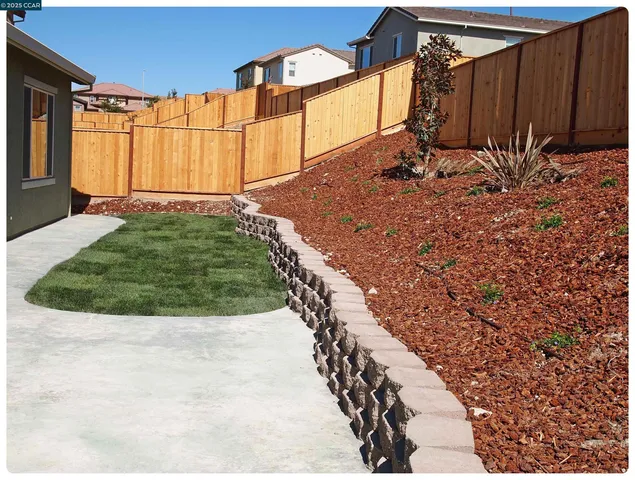 a view of a backyard of the house