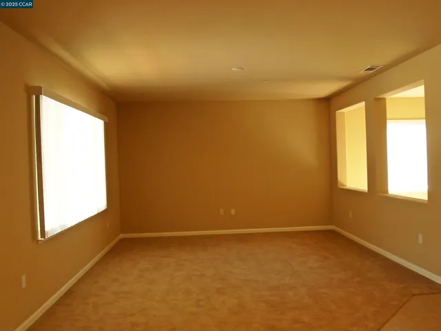 an empty room with a empty space and a window