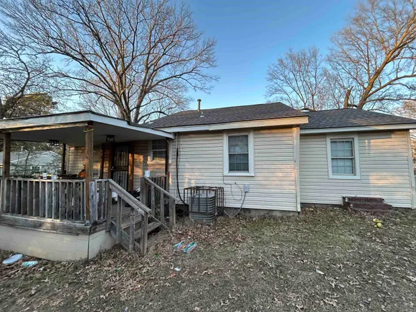 a view of a house with a yard and furniture