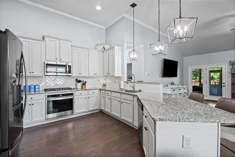 a kitchen with stainless steel appliances granite countertop a stove oven and a refrigerator