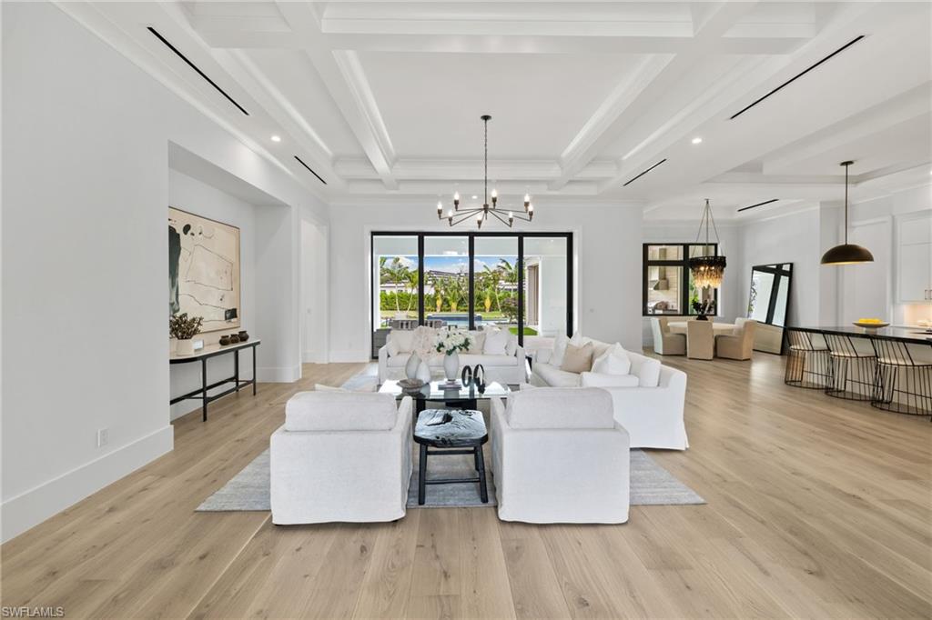 209 Tupelo Road Naples, FL 34108 - Photo 11 of 49 a living room with furniture and wooden floor