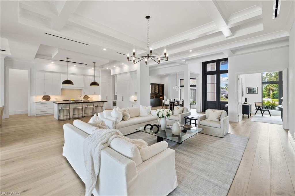 209 Tupelo Road Naples, FL 34108 - Photo 12 of 49 a living room with furniture and chandelier