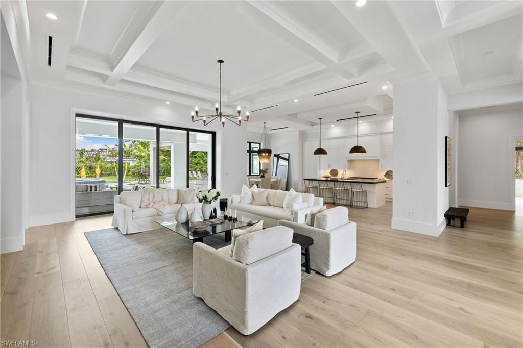 209 Tupelo Road Naples, FL 34108 - Photo 2 of 49 a living room with furniture and a large window