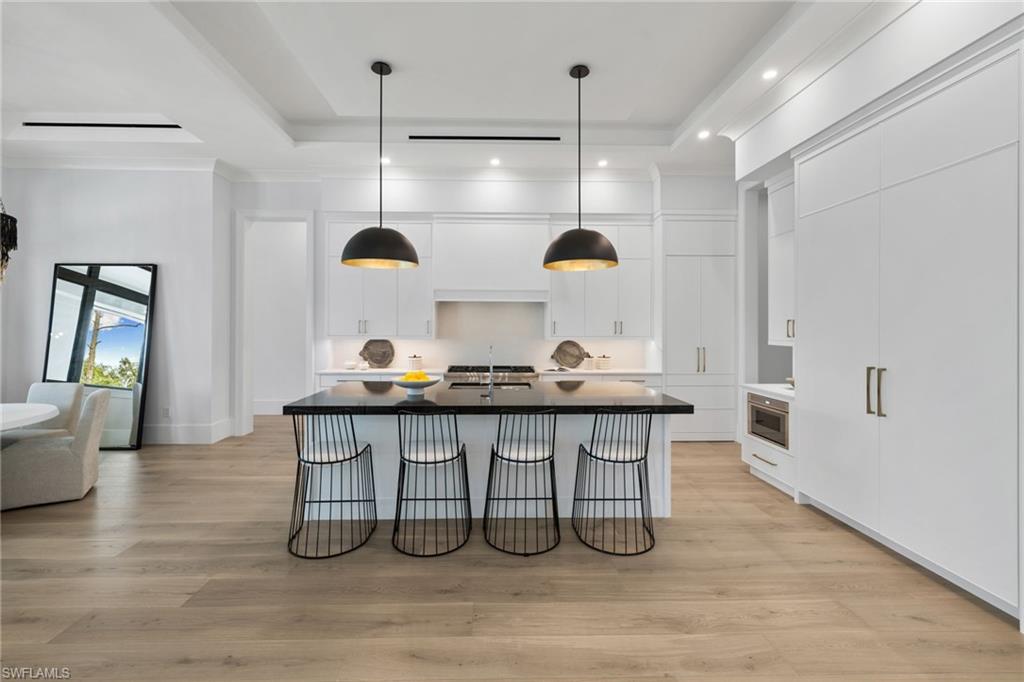 209 Tupelo Road Naples, FL 34108 - Photo 22 of 49 a kitchen with a sink a counter space appliances and cabinets