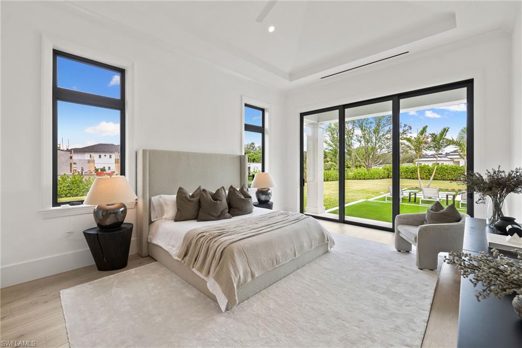 209 Tupelo Road Naples, FL 34108 - Photo 30 of 49 Bedroom featuring access to outside and light wood-type flooring