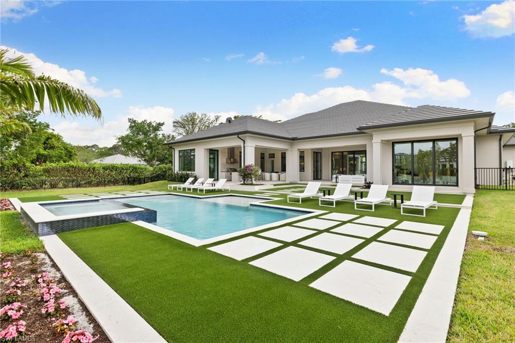 209 Tupelo Road Naples, FL 34108 - Photo 3 of 49 a view of a house with swimming pool and a chairs