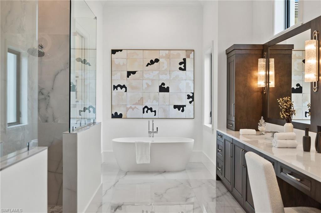 209 Tupelo Road Naples, FL 34108 - Photo 33 of 49 a bathroom with a bathtub sink and mirror