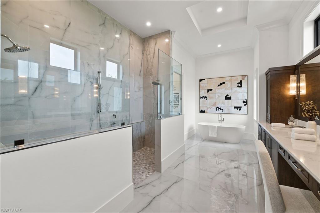 209 Tupelo Road Naples, FL 34108 - Photo 34 of 49 a large bathroom with a glass shower door and a bathtub