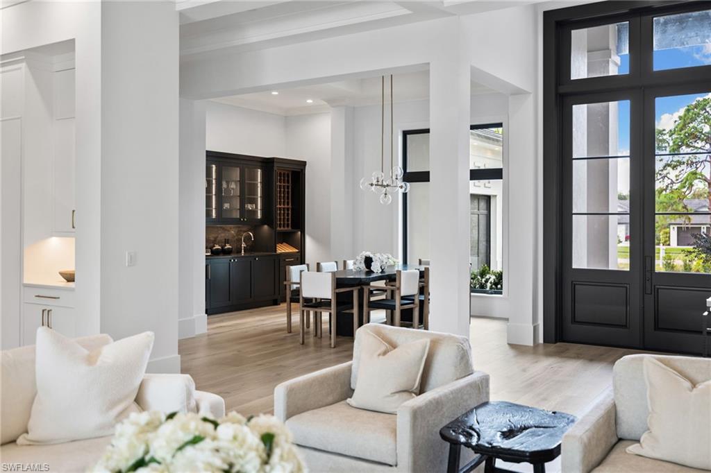 209 Tupelo Road Naples, FL 34108 - Photo 36 of 49 a living room with furniture and floor to ceiling windows
