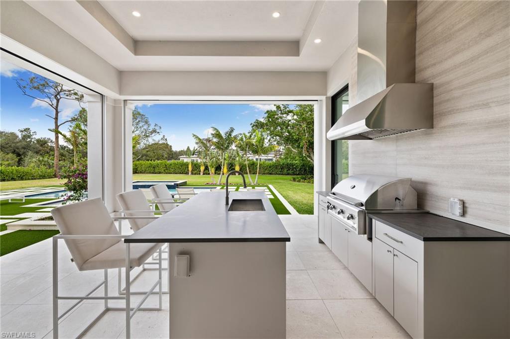 209 Tupelo Road Naples, FL 34108 - Photo 43 of 49 a kitchen with a stove a sink and a refrigerator
