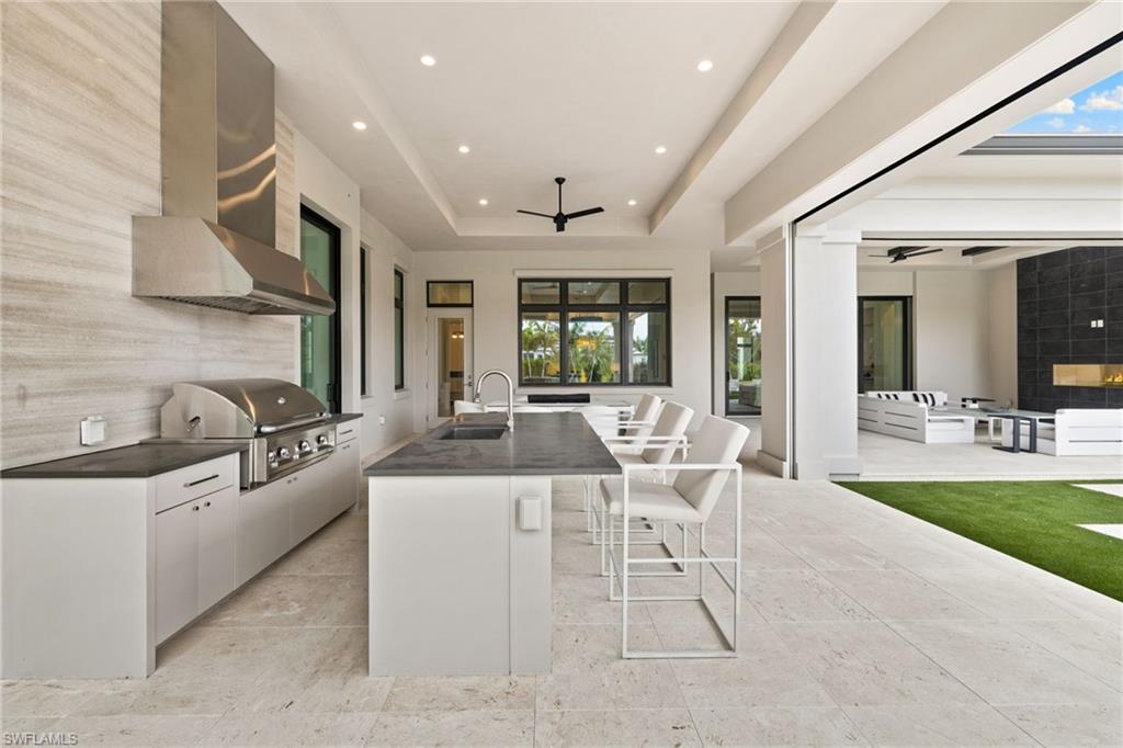 209 Tupelo Road Naples, FL 34108 - Photo 44 of 49 a kitchen with stainless steel appliances kitchen island granite countertop a sink and cabinets