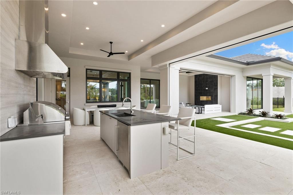 209 Tupelo Road Naples, FL 34108 - Photo 45 of 49 a kitchen with stainless steel appliances granite countertop a sink and a stove