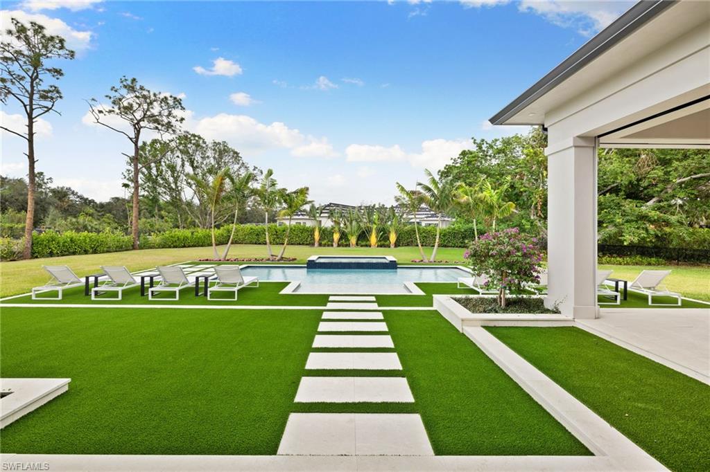 209 Tupelo Road Naples, FL 34108 - Photo 46 of 49 a view of yard with swimming pool and green space