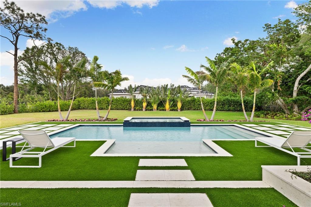 209 Tupelo Road Naples, FL 34108 - Photo 47 of 49 a view of a swimming pool with a yard