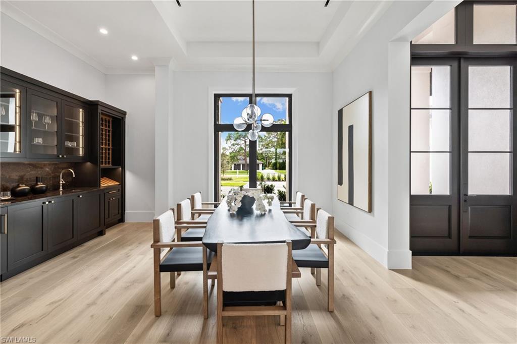 209 Tupelo Road Naples, FL 34108 - Photo 6 of 49 a view of a dining room with furniture window and wooden floor