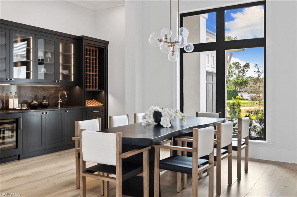 209 Tupelo Road Naples, FL 34108 - Photo 8 of 49 a view of a dining room with furniture window and wooden floor