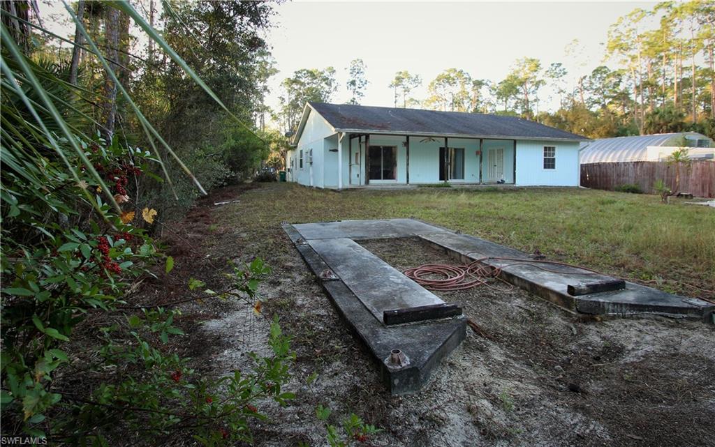 4445 Pine Ridge Road Naples, FL 34119 - Photo 22 of 23 a view of a house with a yard and sitting area