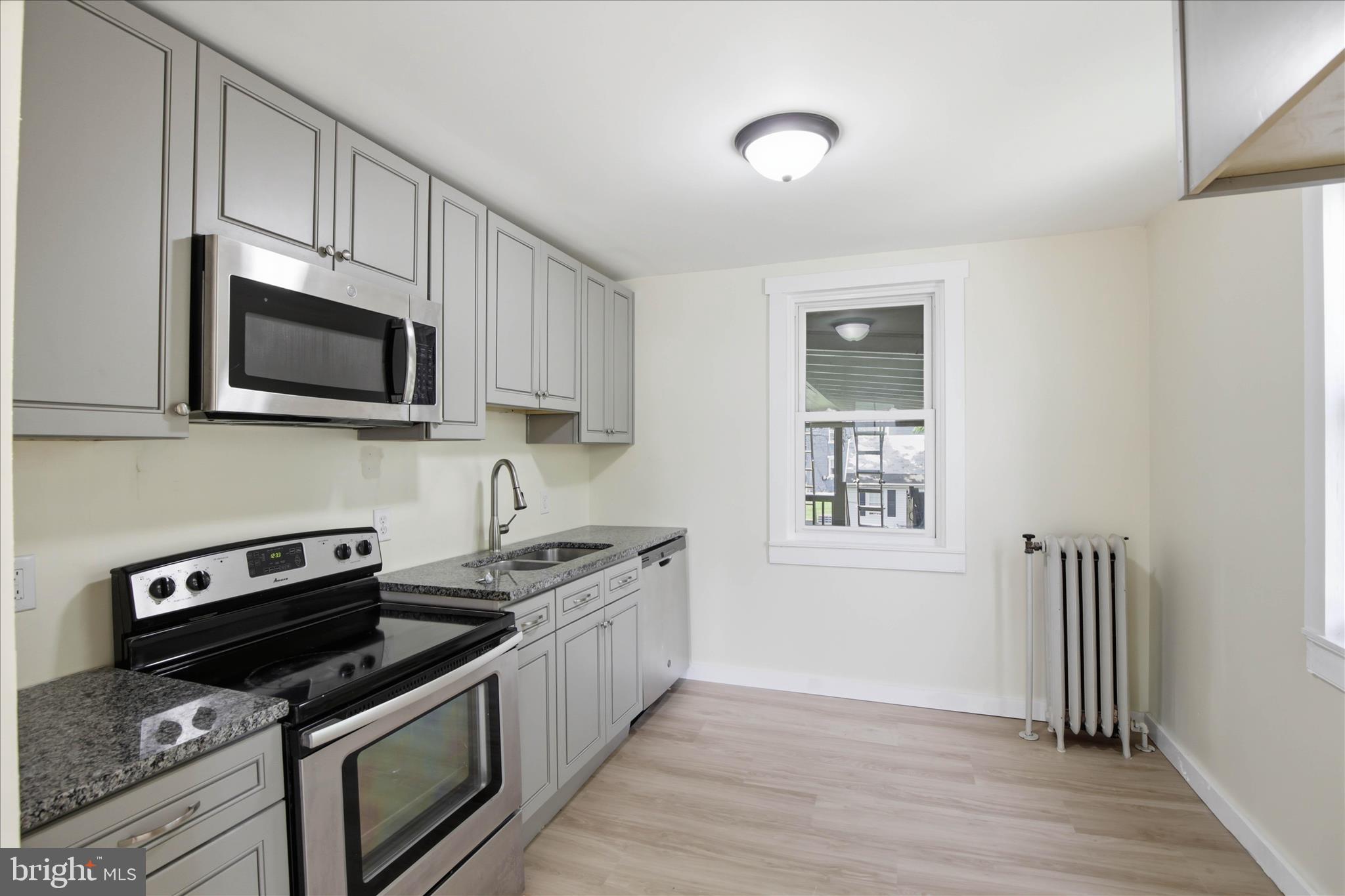101 East Lincoln Avenue Lititz, PA 17543 - Photo 27 of 39 a kitchen with stainless steel appliances a stove a microwave sink and cabinets
