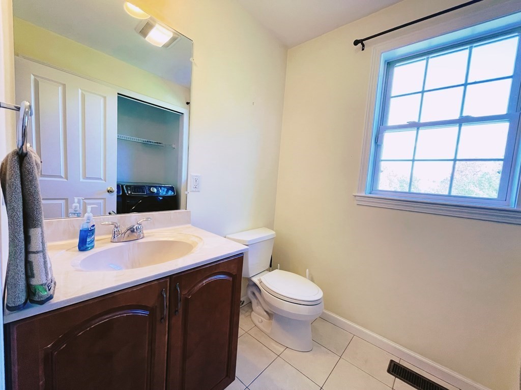 18 Windsor Road Shirley, MA 01464 - Photo 17 of 33 a bathroom with a sink a toilet and mirror