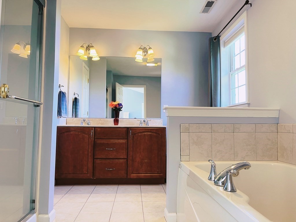 18 Windsor Road Shirley, MA 01464 - Photo 23 of 33 a bathroom with a bathtub sink and mirror