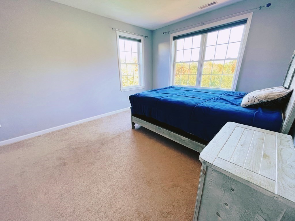 18 Windsor Road Shirley, MA 01464 - Photo 26 of 33 a bedroom with a bed and window