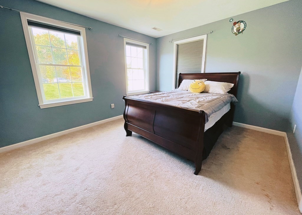 18 Windsor Road Shirley, MA 01464 - Photo 27 of 33 a bed sitting in a bedroom next to a window