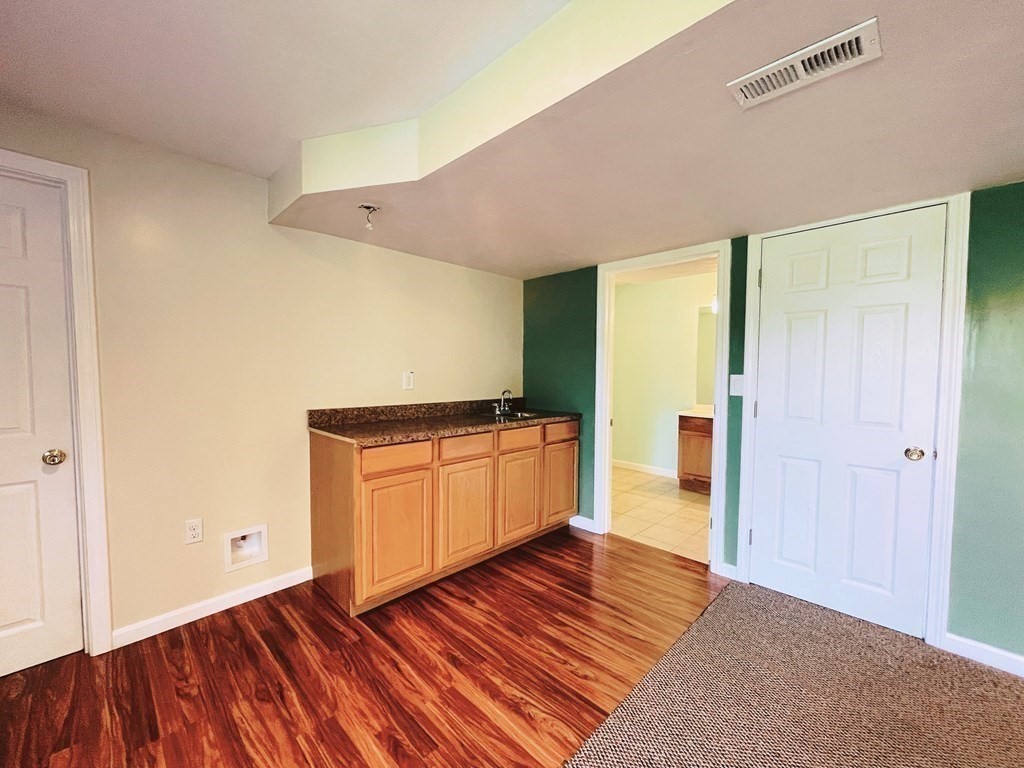 18 Windsor Road Shirley, MA 01464 - Photo 30 of 33 a kitchen with wooden floor and electronic appliances
