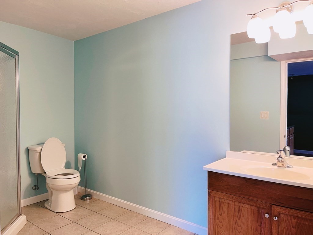 18 Windsor Road Shirley, MA 01464 - Photo 31 of 33 a bathroom with a toilet a sink and mirror