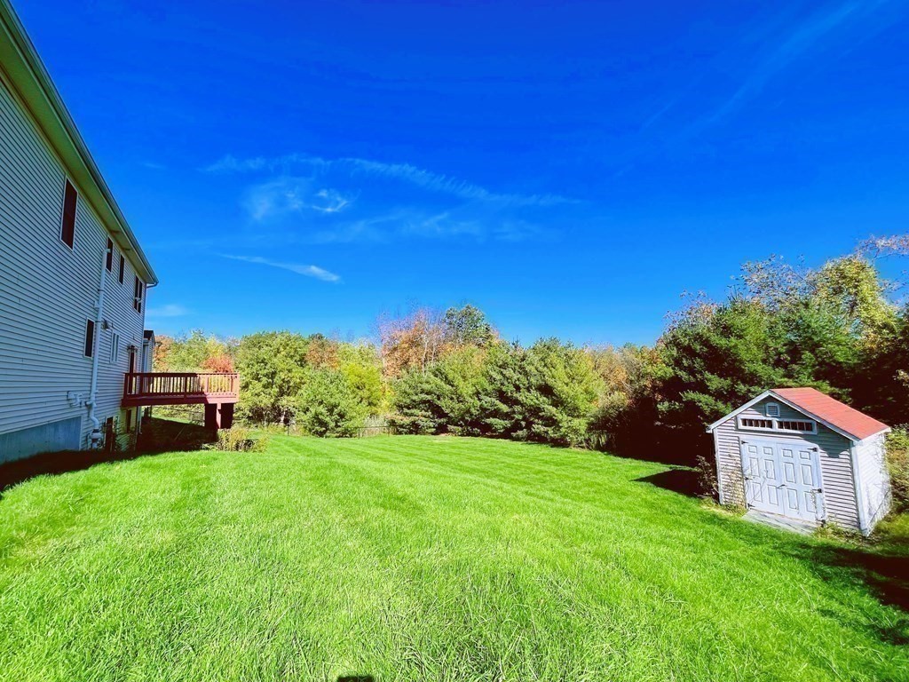 18 Windsor Road Shirley, MA 01464 - Photo 33 of 33 a view of a back yard of the house with a yard