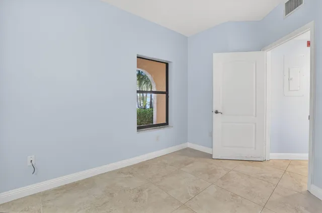 a view of backyard of house with green space