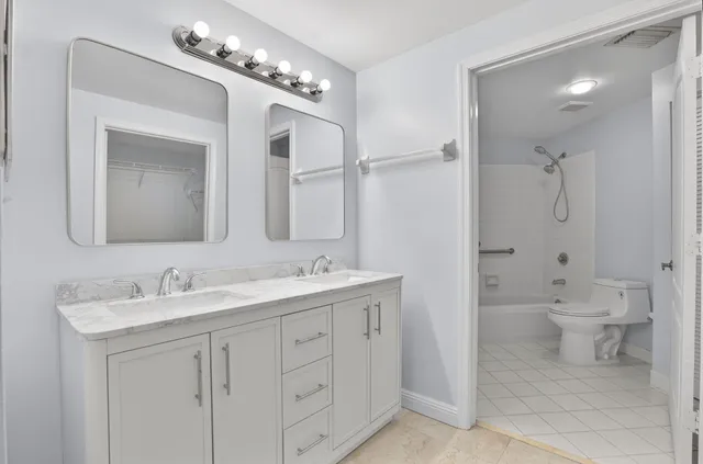a bathroom with a toilet a sink and shower