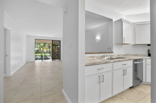 a kitchen with a sink and cabinets