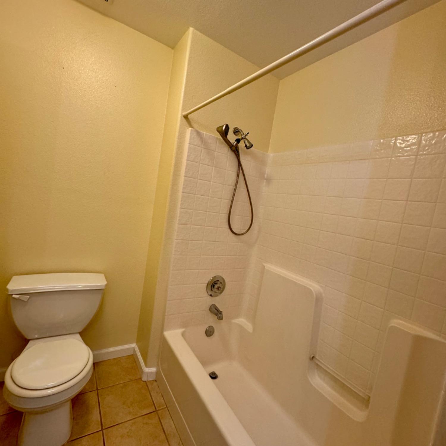 3209 Ren Way Madera, CA 93637 - Photo 16 of 17 a bathroom with a toilet and a shower