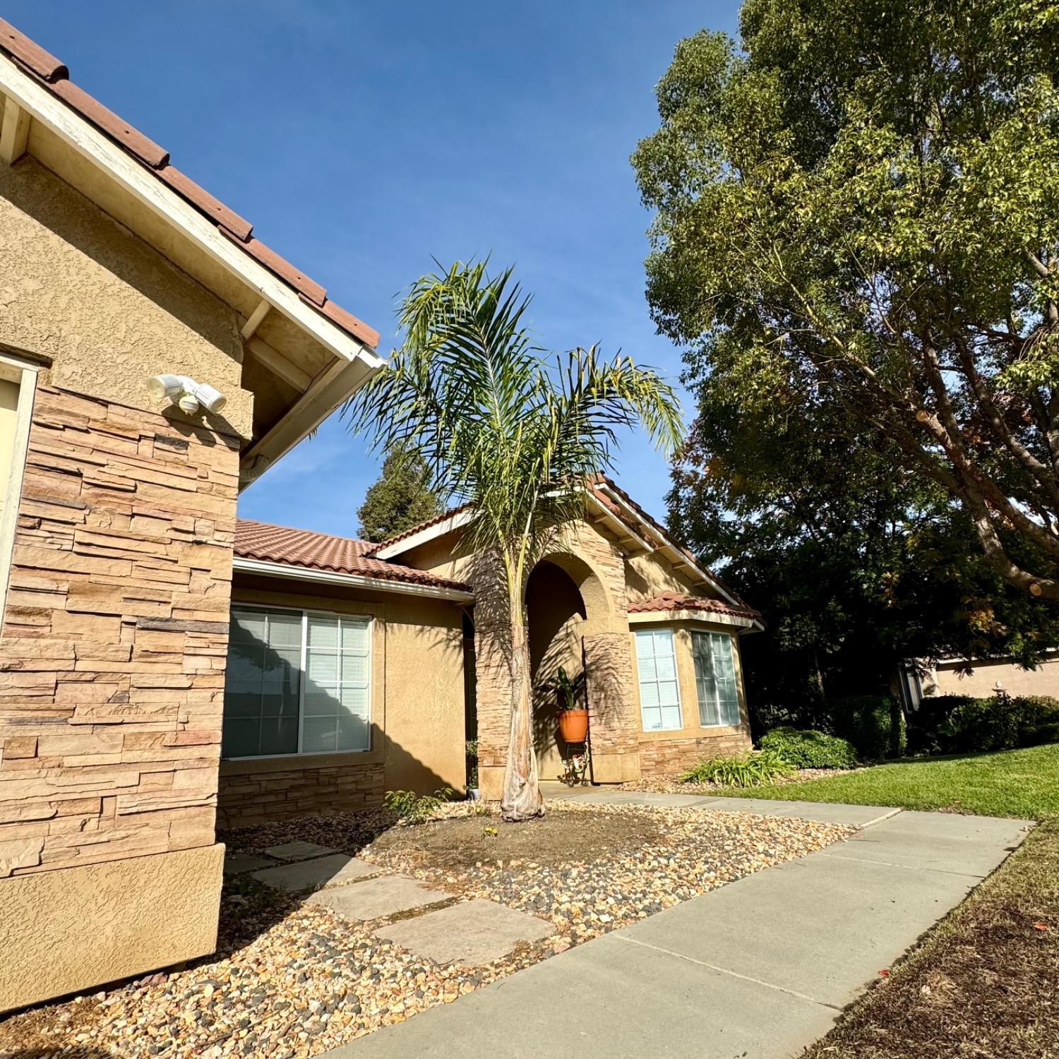 3209 Ren Way Madera, CA 93637 - Photo 3 of 17 a front view of a house with a yard