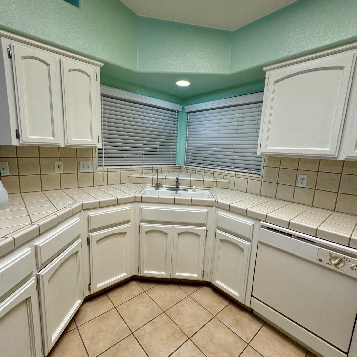 3209 Ren Way Madera, CA 93637 - Photo 7 of 17 a kitchen with sink cabinets and window