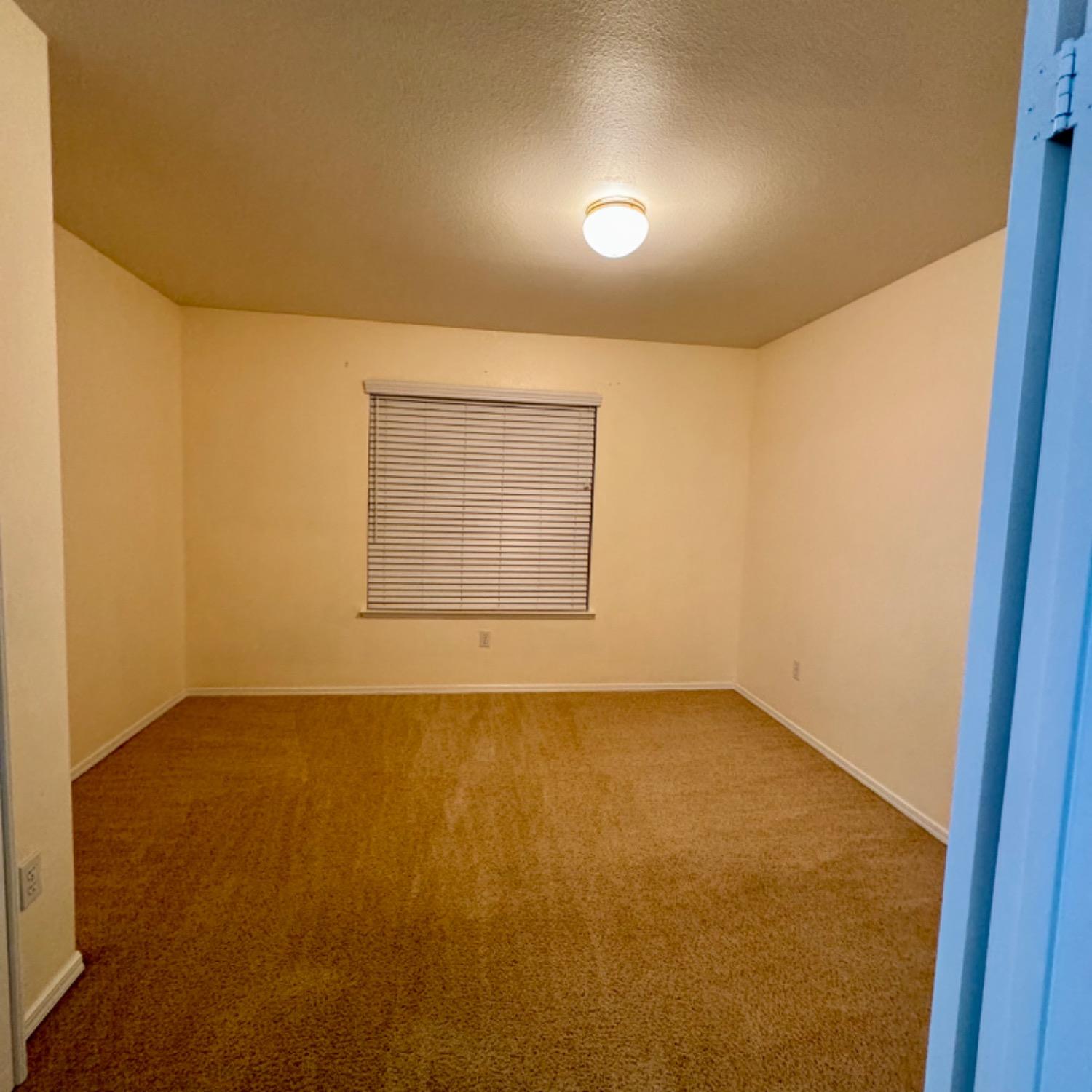 3209 Ren Way Madera, CA 93637 - Photo 8 of 17 an empty room with a empty space and windows