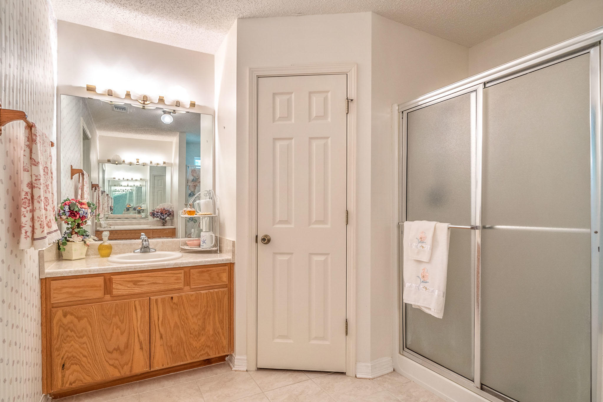 6087 Bud Moulton Road Crestview, FL 32536 - Photo 11 of 30 a bathroom with a double vanity sink and a mirror