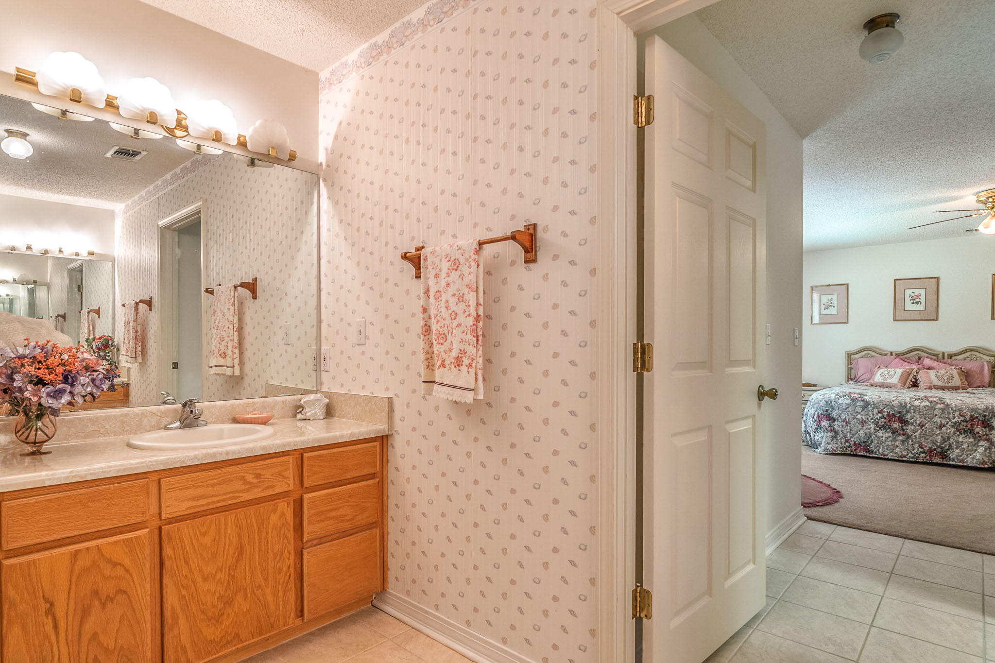 6087 Bud Moulton Road Crestview, FL 32536 - Photo 12 of 30 a bathroom with a double vanity sink mirror and shower