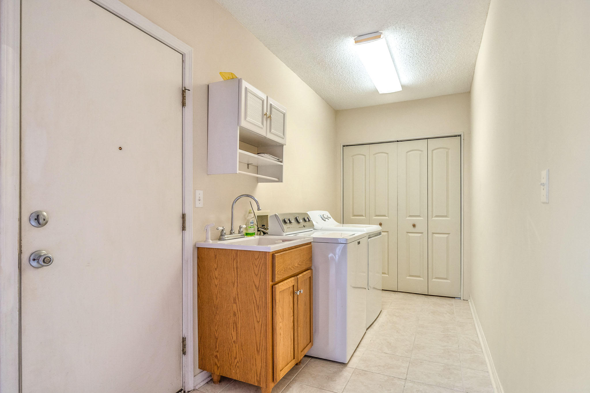 6087 Bud Moulton Road Crestview, FL 32536 - Photo 17 of 30 a utility room with cabinets washer and dryer
